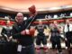 Tocchet Game Puck: Flyers Coach Honors Jason Myrtetus Jason Myrtetus Flyers radio broadcaster holding Rocky gloves in locker room