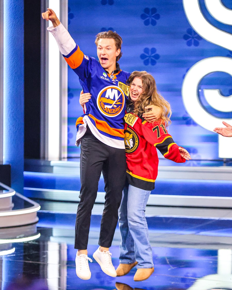 Islanders defenseman Matthew Schaefer celebrates with a contestant on The Price Is Right Tonight set