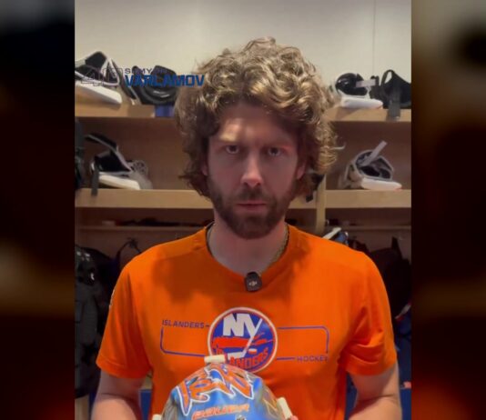 Islanders goalie Semyon Varlamov holds his new 2026-27 mask in the dressing room before his first NHL start since 2024