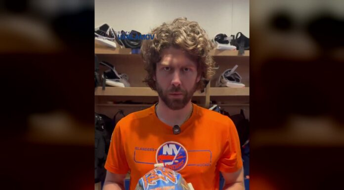 Islanders goalie Semyon Varlamov holds his new 2026-27 mask in the dressing room before his first NHL start since 2024