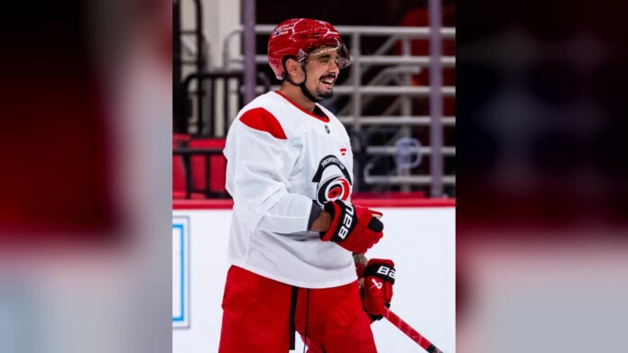 Seth Jarvis Hurricanes regular practice jersey Seth Jarvis smiles at Hurricanes morning skate in a regular practice jersey after shoulder surgery