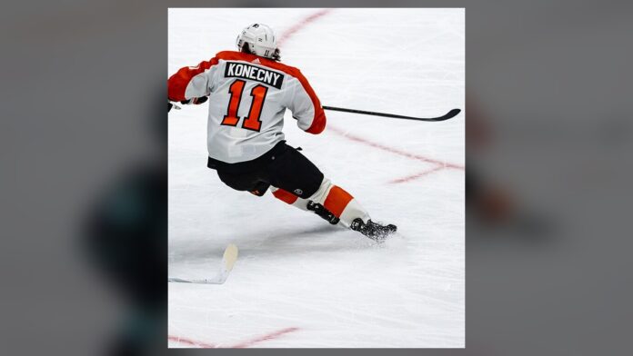 travis-konecny-flyers-trade-talks Travis Konecny Flyers winger skating in white away jersey