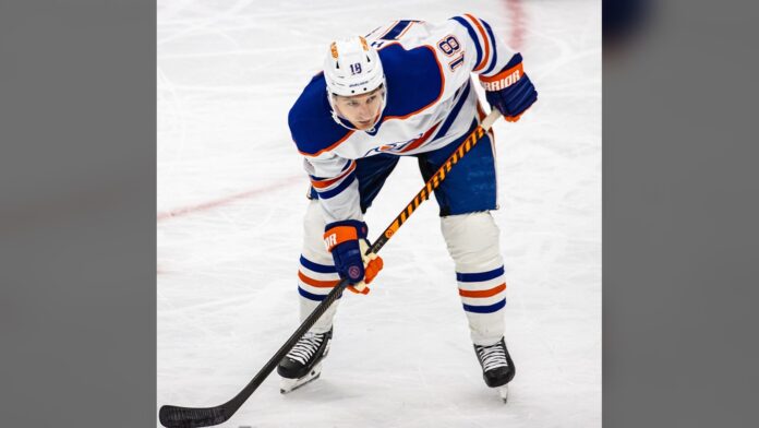 Zach Hyman Oilers injury return Zach Hyman waits for a faceoff in a white Edmonton Oilers jersey